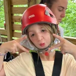 Girl with red helmet ready for zip line