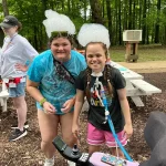 Female camper and counselor with bubble hats