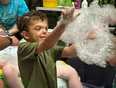 A boy playing with bubbles
