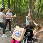 Counselors and camper prepare to fire a large sling shot