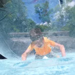 A boy in a large pool bubble