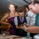 A boy gets finger paint to make his mark.